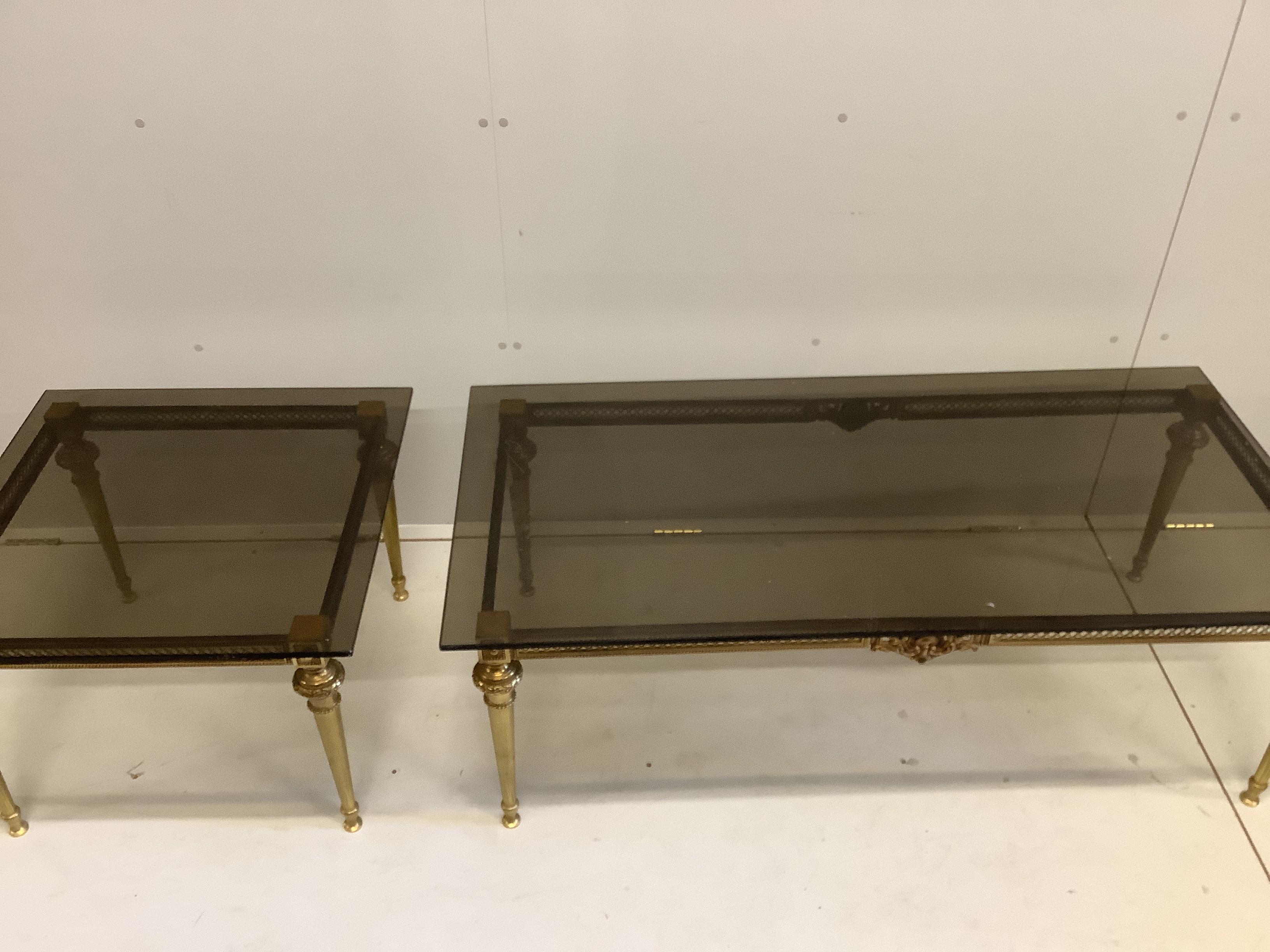 Two brass and smoked glass top coffee tables, larger width 133cm, depth 65cm, height 47cm